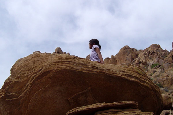Alisha sitting on rock